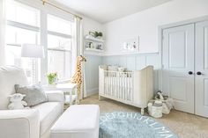 a baby's room with a giraffe in the window and a white crib