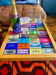 a table topped with wine glasses next to a couch