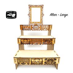 three tiered shelf with mirror on top and drawers below the shelf is decorated in gold filigree