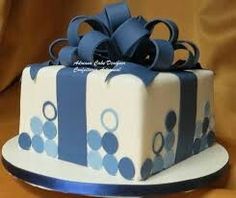 a blue and white cake with a bow on top