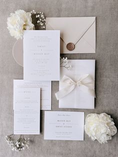 the wedding stationery is laid out and ready for guests to arrive