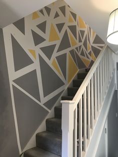 the stairs are painted with yellow and grey triangles