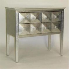 a silver dresser with four drawers on each side and one drawer at the top that is open