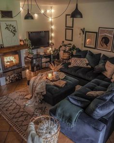 a living room filled with furniture and a fire place next to a wall mounted tv