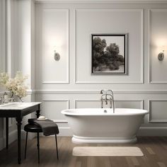 a white bath tub sitting in a bathroom next to two sinks and a table with flowers on it