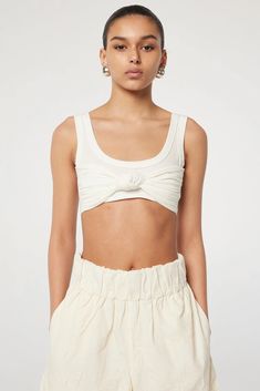 Description Our Spring/Summer iteration of one of our earlier styles, the Inessa is a knotted bralette top crafted from our signature Supima Cotton-Modal jersey. Comfortable and elevated, this top serves as both an underpinning for luxe layers and as a standalone hero piece. Pair yours with the Hadlee skirt for a summe Spring Cropped Twist Front Crop Top, Chic Cropped Bra-friendly Tops, Chic Cropped Bra Friendly Tops, Chic Summer Tops, Bra Friendly, Casual Triangle Top For Loungewear, Chic Cropped Tank Top For Loungewear, Fitted Triangle Top For Loungewear, Versatile Triangle Top For Spring, Chic Cropped Top With Twist Front