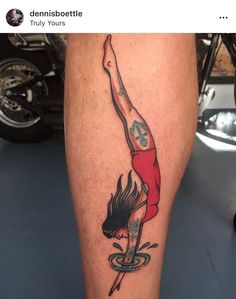 a person with a tattoo on their leg doing a handstand