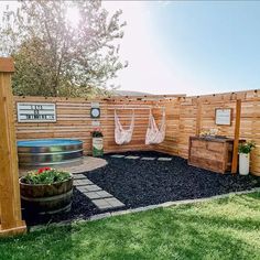 a backyard with a hammock, potted plants and an outdoor hot tub