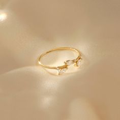 The Leaf Ring is an awesome integration of natural and modern style. The sparkling stones increase its brilliance. It is perfect for everyday wear and wonderful gift for all kind of occasions. - Made in 14k solid gold - Decorated with handset white cubic zirconia stone on 14k solid gold - Band Width: 0.99 mm / 0.038 inches - Thickness: 0,88 mm / 0.034 inches -This product comes with iconic Norm Jewels gift box Elegant Si Clarity Diamond Ring For Anniversary, Minimalist Gold Diamond Ring With White Topaz, 14k Gold Diamond Ring With Si Clarity For Promise, Si Clarity Diamond Rings For Wedding, Wedding Diamond Ring With Si Clarity And Open Shape, Gold Plated Open Diamond Ring With Accents, Gold Plated Diamond Ring With Vvs Clarity, Modern Gold Rings With White Topaz, Modern Cubic Zirconia Promise Ring