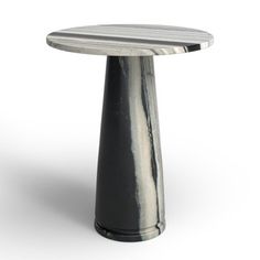 a small round table with a black base on an isolated white background for use in interior or exterior design