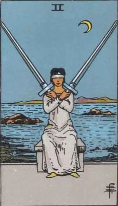 a tarot card with a woman sitting on a bench holding two swords in her hands