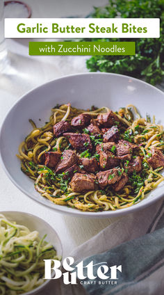 garlic butter steak bites with zucchini noodles in a white bowl on a table