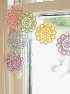 crocheted doily hanging from a window sill