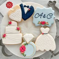 decorated wedding cookies arranged on a plate