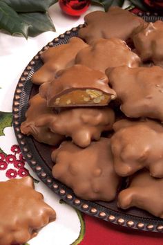 a plate full of chocolate covered cookies on top of a table