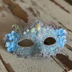 This gorgeous blue lacy mask is lined with a silver trim and embellished with pearls, edged on each side with delicate blooms, iridescent leaves, and eyes are lined with jewels. Backing is black with black elastic band to secure to the head  Ready to ship Bridgerton Halloween Costume, Fairytale Masquerade, Bridgerton Halloween, Mascarade Ball, Bridgerton Ball, Pearl Mask, Shell Crowns, Daphne Bridgerton, Flower Mask