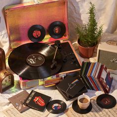 an old record player and some records on a table