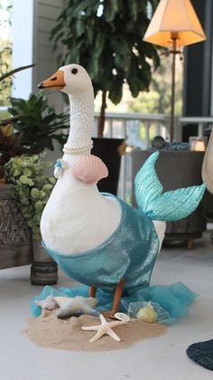 a statue of a white duck with a blue dress on