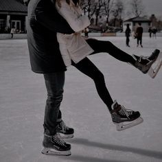 a man and woman skating on an ice rink