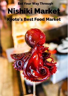 an octopus on a stick with the words eat your way through nishiki market tokyo's best food market