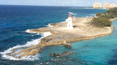 an island with a light house in the middle