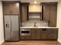 a kitchen with wooden cabinets and stainless steel appliances