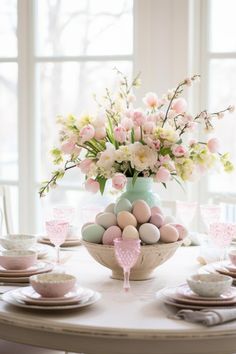 an easter table setting with pink and white flowers in a vase on the centerpiece