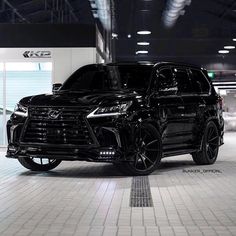 a black suv is parked in a garage