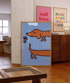 there are posters on the wall in this living room, and one has a dachshund holding a flower