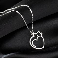 "Cat Heart Pendant Charm Necklace, Cute Heart Shaped Cat Necklace in Sterling Silver is made by hand in our workshop with care. All our jewelry is the most elegant choice for the Bridesmaids, friends, your loved ones and for yourself. Cat Heart Pendant Charm Necklace * Material: High Quality Solid 925 Sterling Silver. * Dimensions: Depending on your font choice, height sizes range from 1,5 mm to 3,5 mm lowercase. * Finish: Sterling Silver ∙ Gold ∙ Rose Gold. HOW TO ORDER ❓ * Select your necklace COLOR. * Choose necklace length from 14\" to 22\". The length option is the TOTAL chain length (including the charm). If you order an 18\" chain, the piece will come as CHAIN + CHARM = 18\".  * Finish your payment and complete your order. PRODUCTION TIME 🕒 All items made to order. Production start Silver Heart-shaped Cat Design Jewelry, Valentine's Day Gift Necklace With Cat Design, Valentine's Day Cat Design Necklace Gift, Valentine's Day Gift Cat Design Necklace, Silver Cat Design Jewelry For Mother's Day, Valentine's Day Cat Design Jewelry Gift, Wire Wrap Jewelry Designs, Cat Heart, Necklace Cute