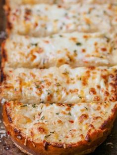 a cheesy pizza sitting on top of a wooden cutting board