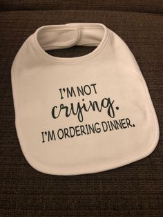 White one-size bib. Perfect for 6 month +. Decorated with the words: I'm not crying. I'm ordering dinner. Shirt Quotes, Gender Neutral Baby Clothes, Dinner Date, Buffalo Ny, Baby Star, T Shirts With Sayings, Gender Neutral Baby, Unisex Baby