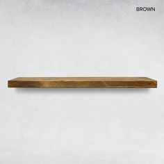 a wooden shelf on the wall in front of a white background with text that reads brown