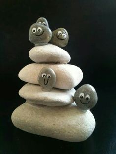 three rocks stacked on top of each other with faces painted on them and eyes drawn on the rocks