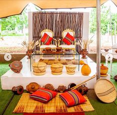 the table is set up with baskets, plates and other decorative items on top of it