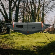 a hammock hanging from a line in the grass