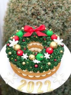 a decorated christmas wreath on top of a cake