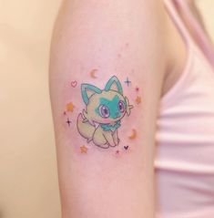 a woman's arm with a small tattoo of a cat and stars on it