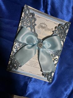 a wedding card with a blue bow on it