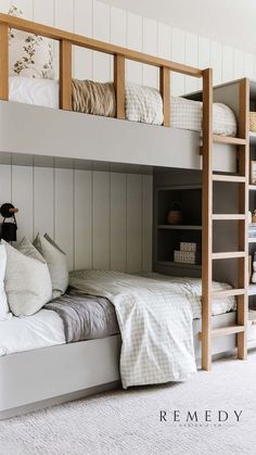 there is a bunk bed with two sets of pillows on the bottom and one side