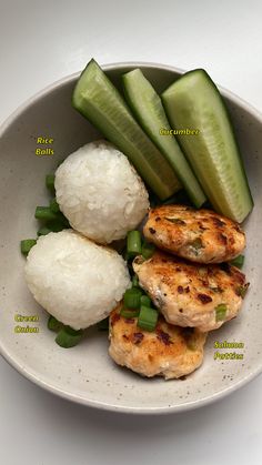 a bowl with rice, cucumbers and chicken on it