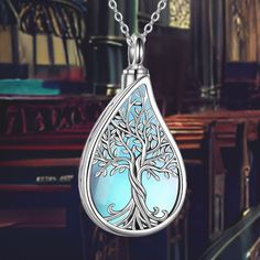 This elegant Tree of Life Teardrop Cremation Necklace combines the powerful symbolism of the Tree of Life with the shape of a teardrop, symbolizing eternal life, immortality, and reincarnation. The necklace is designed to keep the memory of a loved one close to your heart at all times. Design Symbolism: The Tree of Life represents eternal life, growth, and strength, making it a profound symbol of remembrance and continuity. The teardrop shape adds a poignant element, symbolizing love and loss. E Spiritual Silver Teardrop Pendant Jewelry, Spiritual Nickel-free Teardrop Necklace, Spiritual Sterling Silver Teardrop Necklace, Spiritual Silver Pendant Drop Necklace, Spiritual Engraved Teardrop Pendant Jewelry, Engraved Teardrop Spiritual Jewelry, Spiritual Teardrop Jewelry For Healing, Silver Water Drop Necklace For Gift, Spiritual Healing Teardrop Jewelry