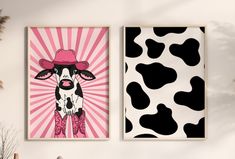 two cow prints are hanging on the wall