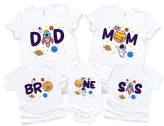 three white onesuits with the words dad, mom and baby printed on them