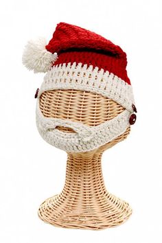 a white and red knitted hat on top of a wicker mannequin head