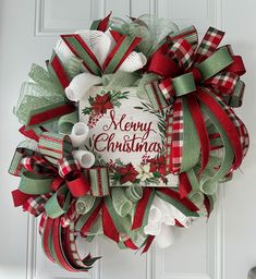 Add a touch of elegance to your holiday decor with this handcrafted "Merry Christmas" wreath! Featuring rich red, green, and white ribbons, along with a blend of plaid and striped designs, this wreath is perfect for creating a festive welcome. The beautiful "Merry Christmas" sign at the center is adorned with poinsettias and holly, bringing the classic Christmas look to life. This wreath is ideal for hanging on your front door, above the fireplace, or anywhere in your home to spread holiday cheer. Details: Size: Approximately 23-24 inches in diameter 6-7 inches deep (from tip to tip) Colors: Red, Green, White Materials: Premium ribbons, wired wreath base, decorative mesh Suitable for indoor or covered outdoor use Themed Wreaths, Christmas Decor Trends, Poinsettia Wreath, Merry Christmas Sign, Holiday Door, Christmas Tree Shop, Fabric Ornaments, White Ribbon