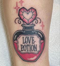 a woman's leg with a tattoo on it that says love potion and a diamond in a bottle