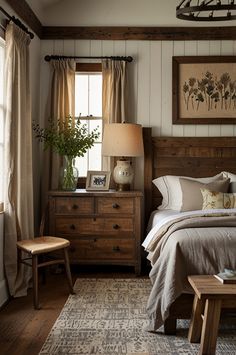 a bed room with a neatly made bed next to a night stand and two windows