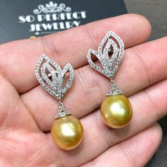 We are presenting you A PAIR OF matching SOUTH SEA PEARLS with LUSTROUS GOLDEN color. SET IN HANDCRAFTED, 18K SOLID GOLD DROP EARRINGS. ACCENTED WITH 116 E/VS, SPARKLING ROUND BRILLIANT DIAMONDS! IN CASE OF RETURN FOR US BUYERS. BUYERS MAY SEND THE ITEMS BACK TO OUR US-BASED OFFICE IN SALT LAKE CITY, UTAH ONLY ONE ITEM AVAILABLE!! NO DUPLICATES!! WHAT YOU SEE IN THE PICTURES IS WHAT YOU WILL GET SOLIDLY HANDCRAFTED EARRINGS! SUGGESTED RETAIL VALUE: $9,880 PEARLS: Size: 12 x 11 mm Shape: Oval/Rou Luxury Yellow Earrings For Wedding, Luxury Pearl Drop Earrings For Anniversary, Luxury Drop Pearl Earrings For Anniversary, Luxury Gold Teardrop Bridal Earrings, Anniversary Luxury Drop Pearl Earrings, Pear-shaped Yellow Gold Bridal Earrings For Anniversary, Yellow Gold Pear-shaped Bridal Earrings For Anniversary, Elegant Pear-shaped Yellow Earrings, Elegant Yellow Pear-shaped Earrings