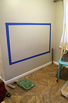 the room is being painted with blue tape